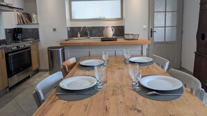 A modern kitchen with a dining area set for four.