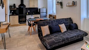 A modern apartment with a kitchen, dining area, and living room.
