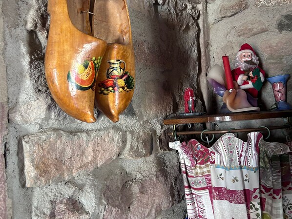 A rustic interior with a wooden sculpture, a Santa figurine, and patterned fabric. - Family cottage for 8, historic charm & modern comfort (Fresse)
