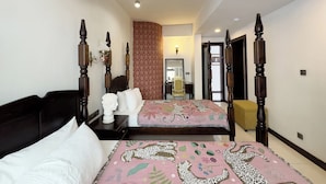 Une chambre à coucher avec un lit à baldaquin, une table de chevet, un miroir et un buste décoratif.
