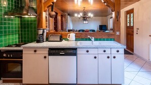 A kitchen with a central island, a dishwasher, and a stove.