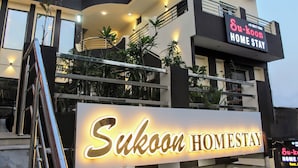A modern building with a sign that reads "Sukoon Homestay." - sukoon homestay (Agra)