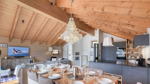 A modern kitchen with dark cabinets and a built-in oven. - Cozy chalet in Méribel with jacuzzi, sauna, 4 bedrooms (Méribel)