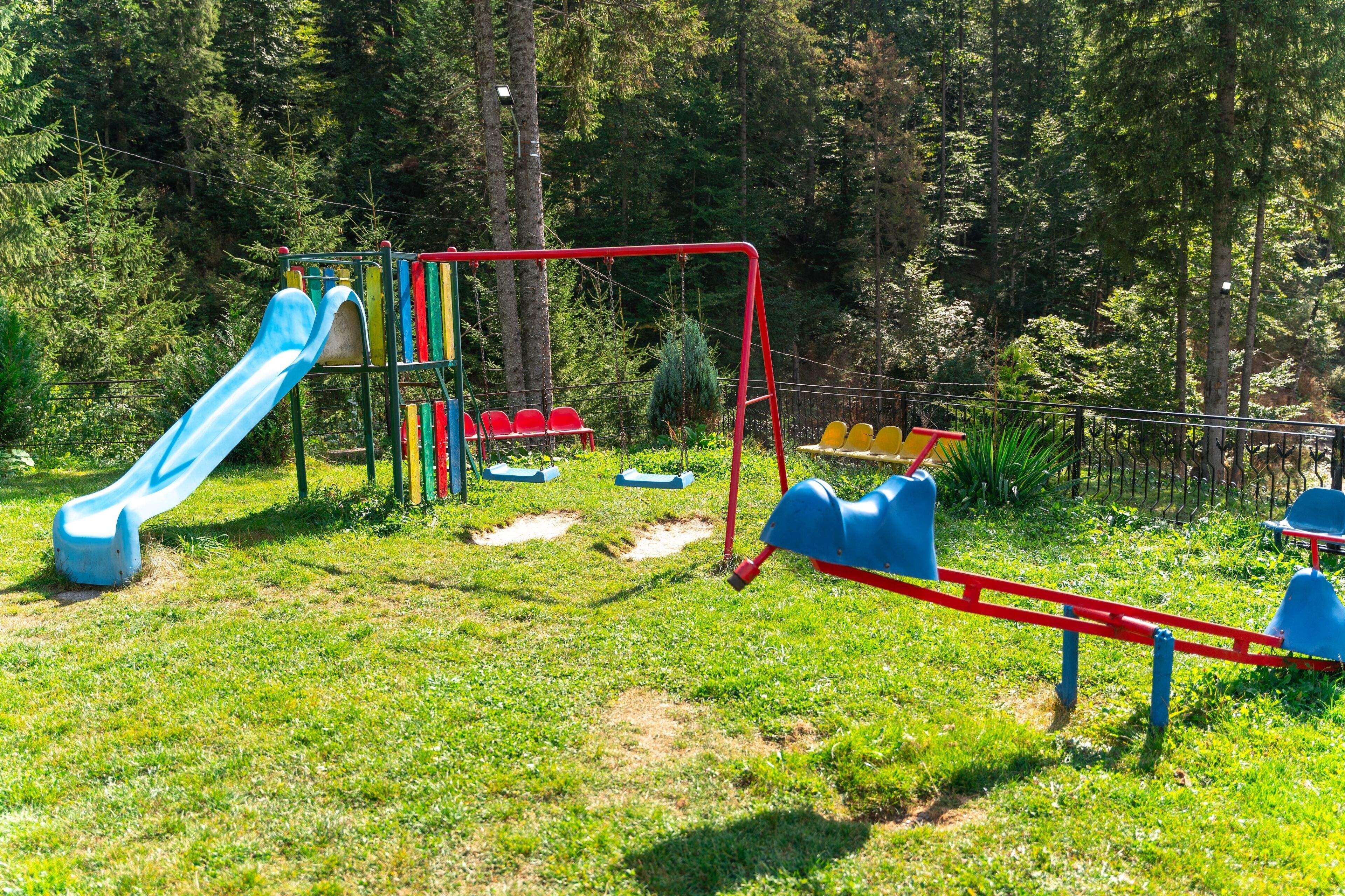 A playground with a slide, swings, and a climbing structure.