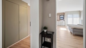 A modern bedroom with a bed, a bedside table with a plant, and a wardrobe. - Black Forest moment at Monbachtal (Bad Liebenzell)