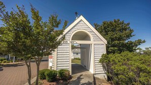 A small, single-story building with a pitched roof and an arched entrance.