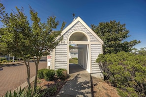 A small, single-story building with a pitched roof and an arched entrance.