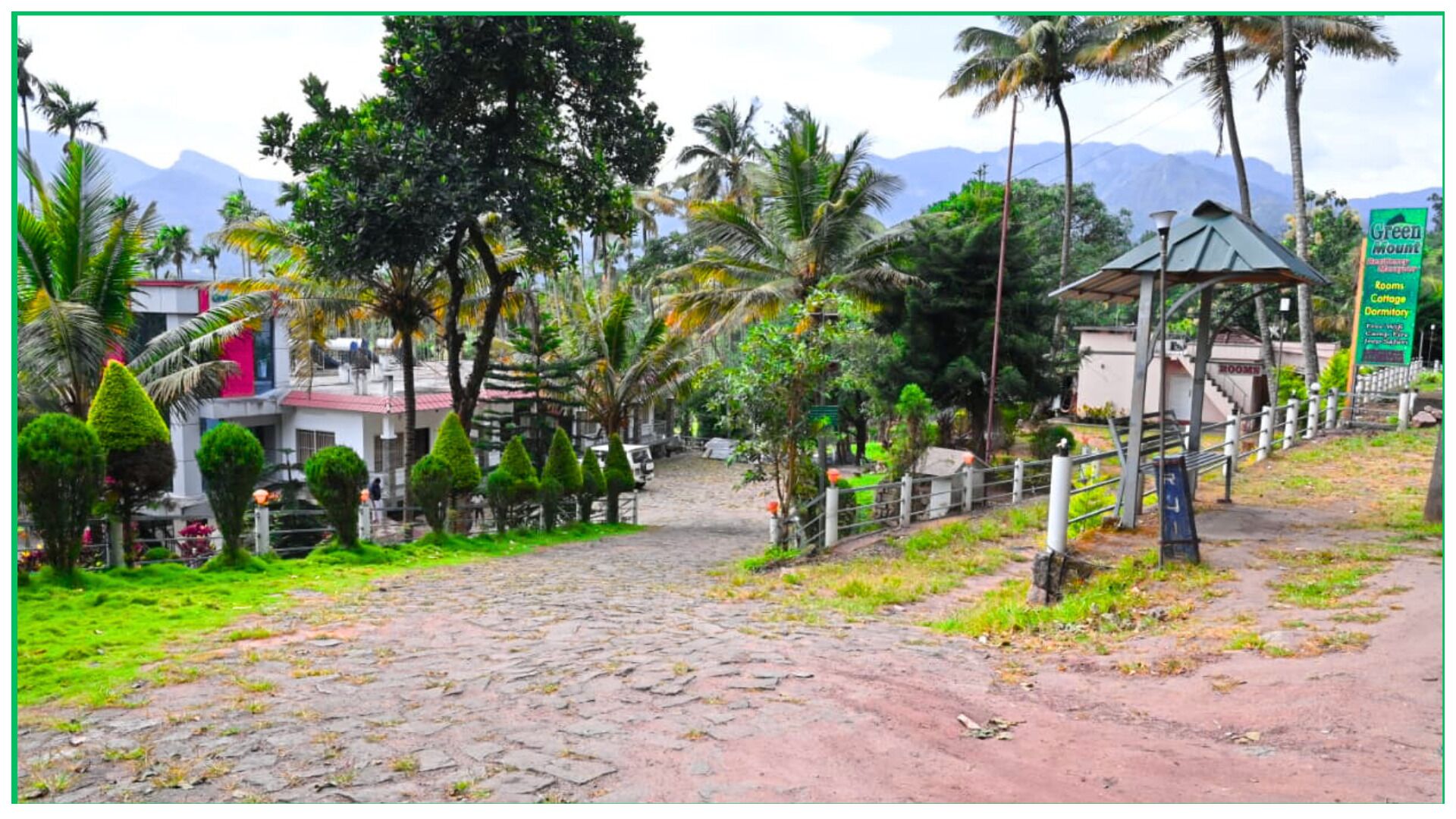 A paved pathway leading to a building with a sign indicating 'Green Mount' and 'Cottage Dormitory'.
