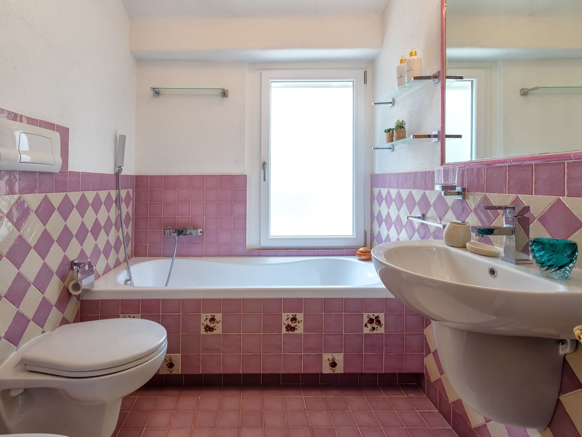 A bathroom with a toilet, bathtub, and sink.