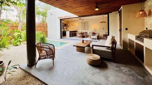 A modern outdoor living area with a pool, seating, and a kitchen area. - 2-BD Deluxe Villa 2 Private Pools & Grill (Tulum)