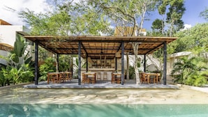 A covered outdoor dining area with a pool in the foreground. - 2-BD Deluxe Villa 2 Private Pools & Grill (Tulum)