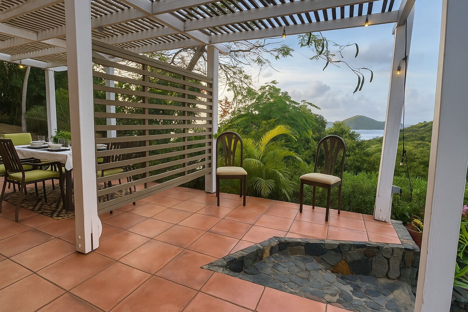 An outdoor patio with a pergola, a dining table with chairs, and a stone fire pit.