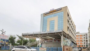 A multi-story hotel with a prominent sign for Hotel Rose Gold AC Rooms. - Hotel Rose Gold (Vadodara)