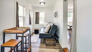 A cozy living room with a sofa, a wooden coffee table, and a foosball table. - 15 Mi to Downtown Sioux Falls: Gem w/ Yard! (Hartford)