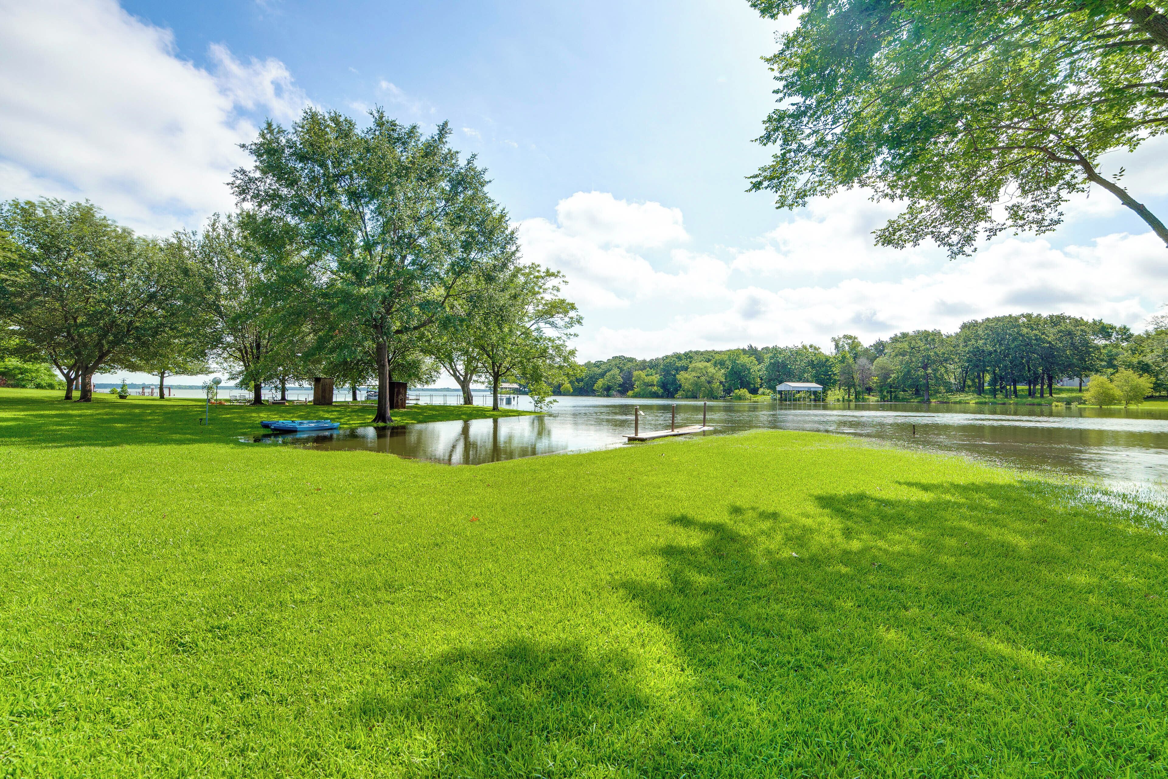 A park with a lake, trees, and a grassy area.