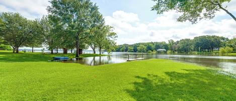 A park with a lake, trees, and a grassy area.