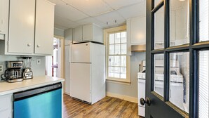 A kitchen with white cabinets, a dishwasher, a refrigerator, and a coffee maker. - Near Shops & Parks: Dog-friendly Maryland Gem (Owings Mills)