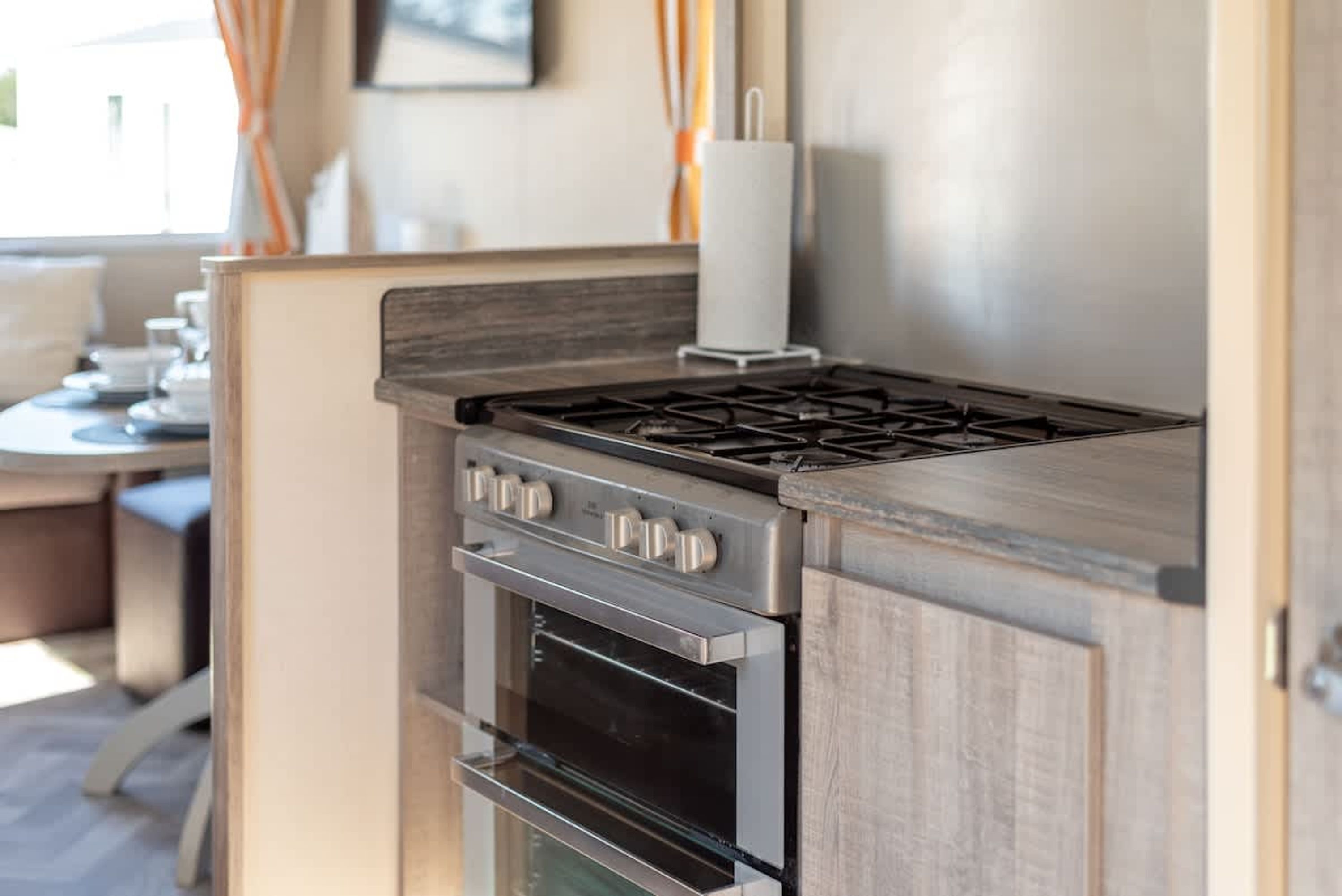 A compact kitchen with a gas stove, oven, and a built-in microwave.