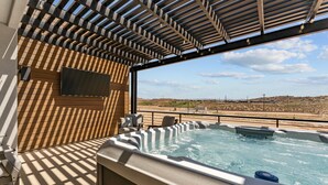 A hot tub area with a view of the desert landscape.