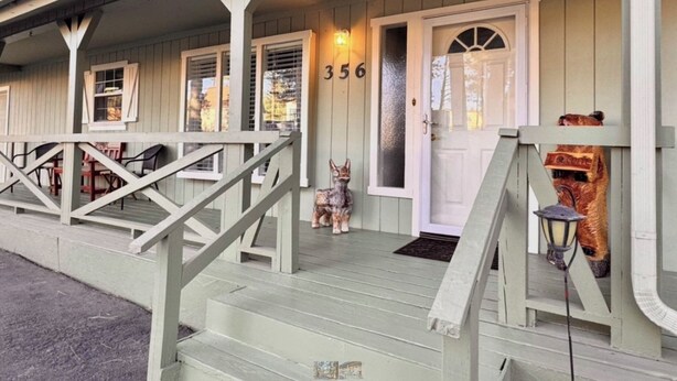 A wooden building with a porch, a staircase, and a door marked with the number 356. - Mountain Sage Retreat | Great Location, Fenced Yard (Ruidoso)