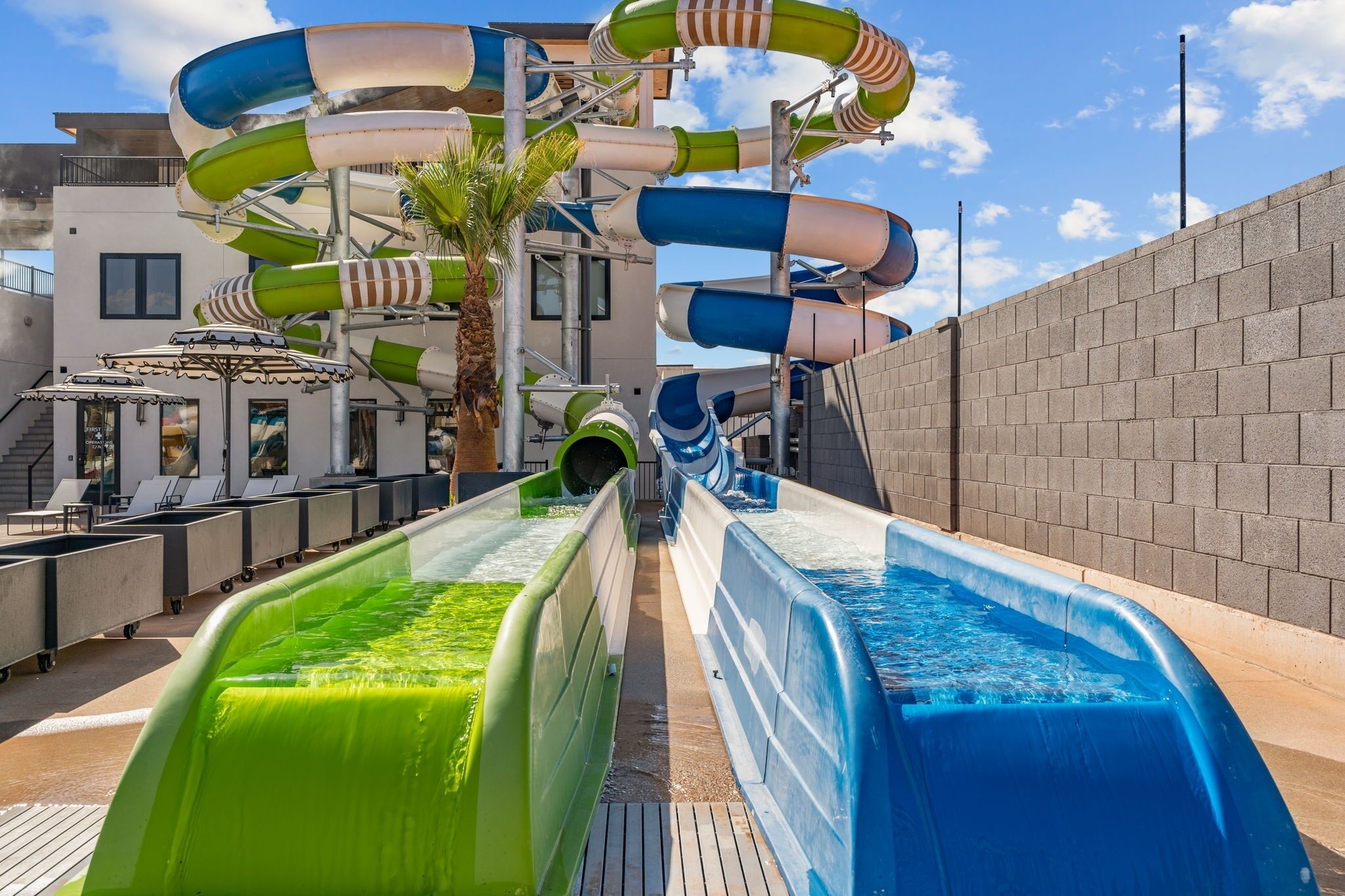 A water park area with multiple slides and a pool.