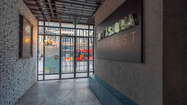A modern entrance with a metal roof, a glass door, and a sign reading "OFFASORIA BUDAPEST". - ASTORIA Loft Elite Apartment free parking,AC,Elevator (Budapest)