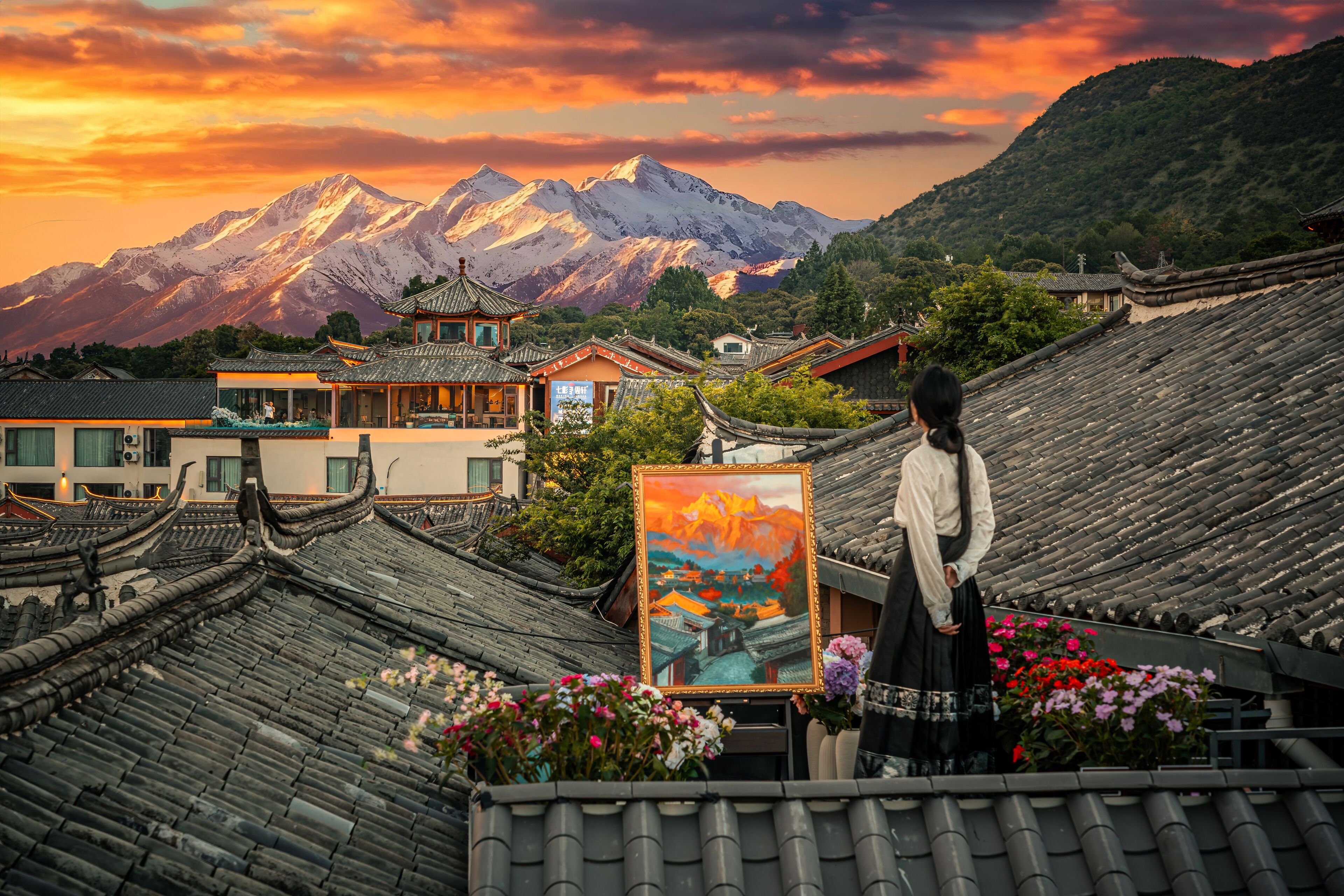 A traditional building with a tiled roof and a painting of a mountain landscape.