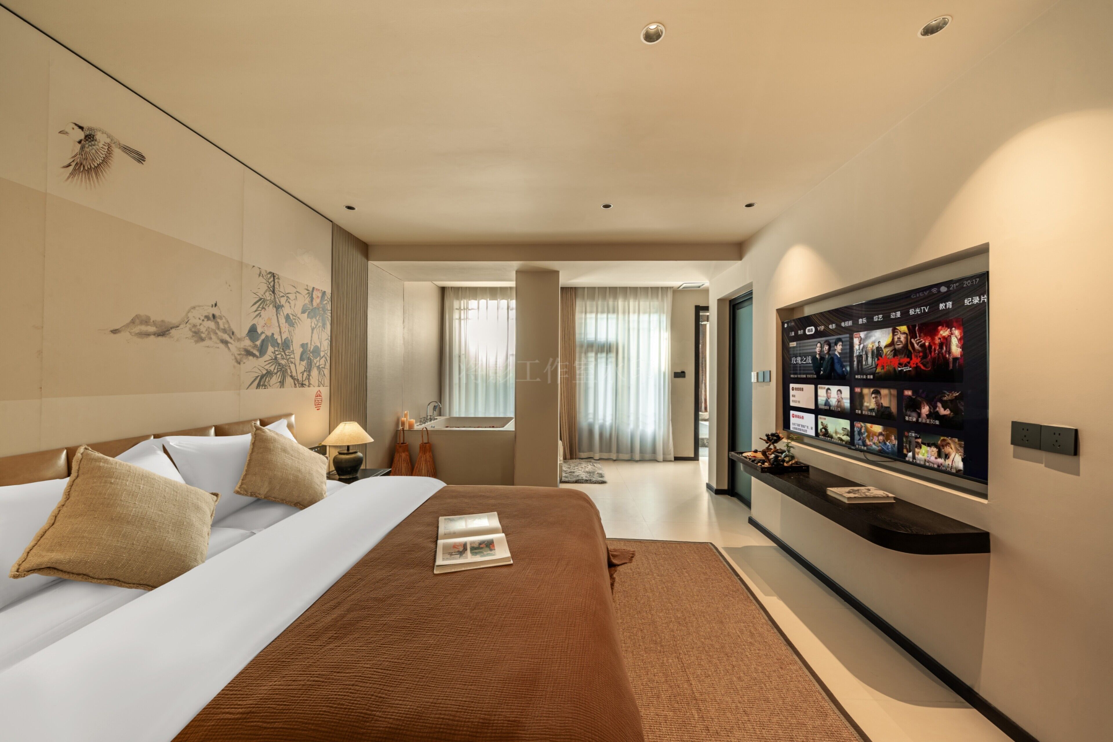 A hotel room with a large bed, a flat-screen TV, and a view of the hallway.