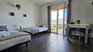 A hotel room with two beds, a desk, chairs, and a balcony with a view. - T2 Dolce & Vita B4 sea and pool view (Propriano)