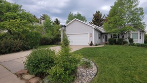 A single-story house with a front yard, a driveway, and a garage. - 4-bedroom house in highly desirable Southside Bozeman with AC and heated garage. (Bozeman)