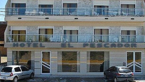 A two-story hotel with balconies on the upper floor and a sign reading "HOTEL EL PESCADOR". - Hotel El Pescador (Mar de Ajo)