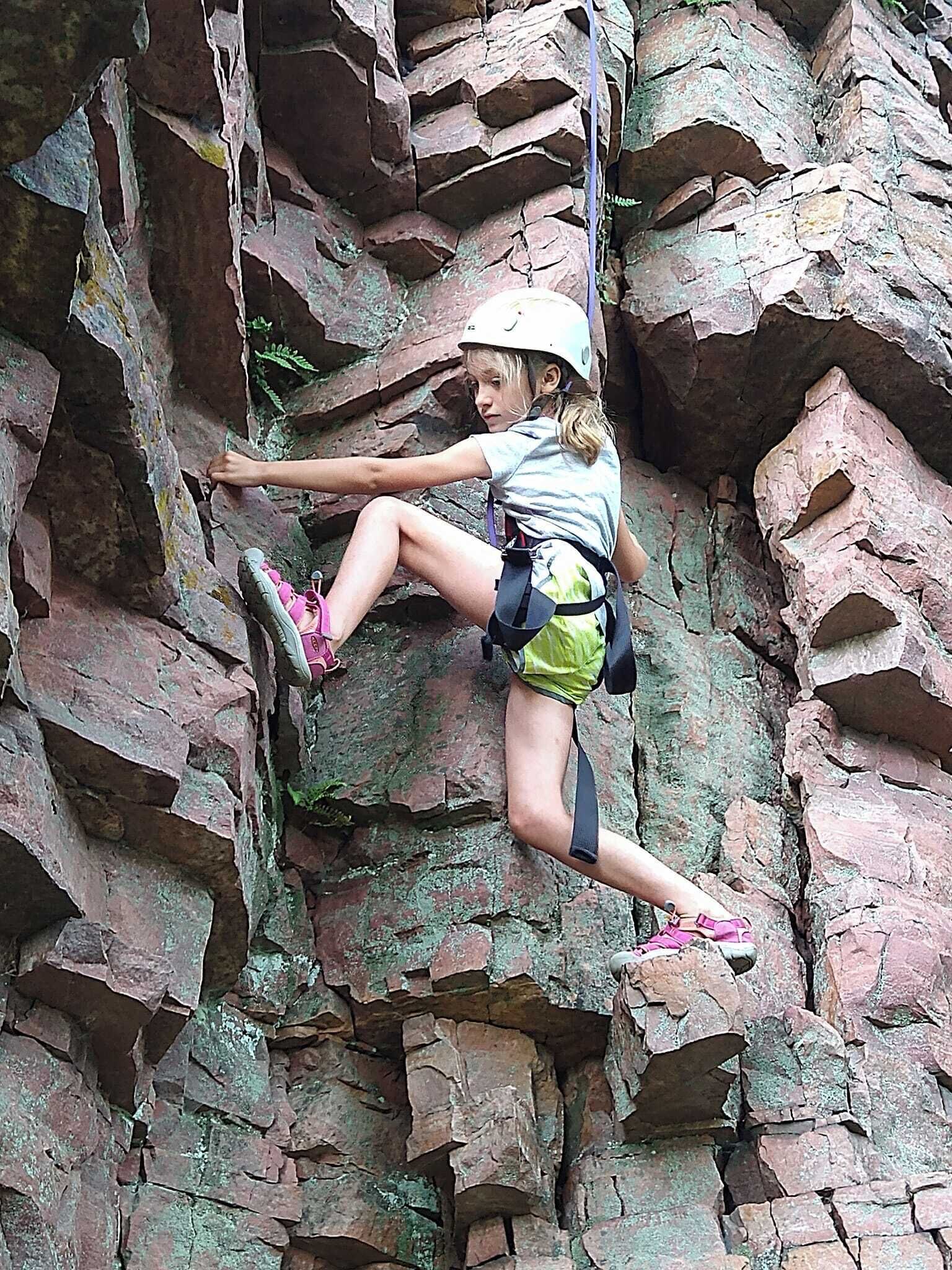 A person rock climbing on a rocky wall.