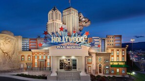 L’entrée du musée de cire de Hollywood, avec un grand panneau indiquant « Hollywood » et une statue de gorille.