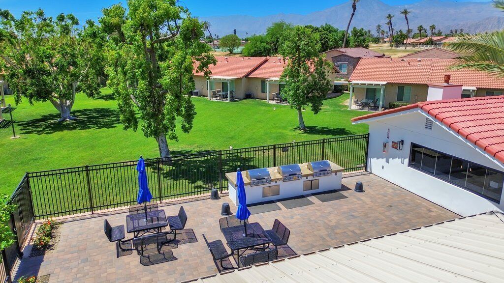 A patio area with outdoor seating and a barbecue grill.