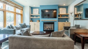 A living room with a fireplace, sofas, and a TV. - Modern Ideal Ski Location, Views, Heated Garage, Elevator 633 (Mammoth Lakes)