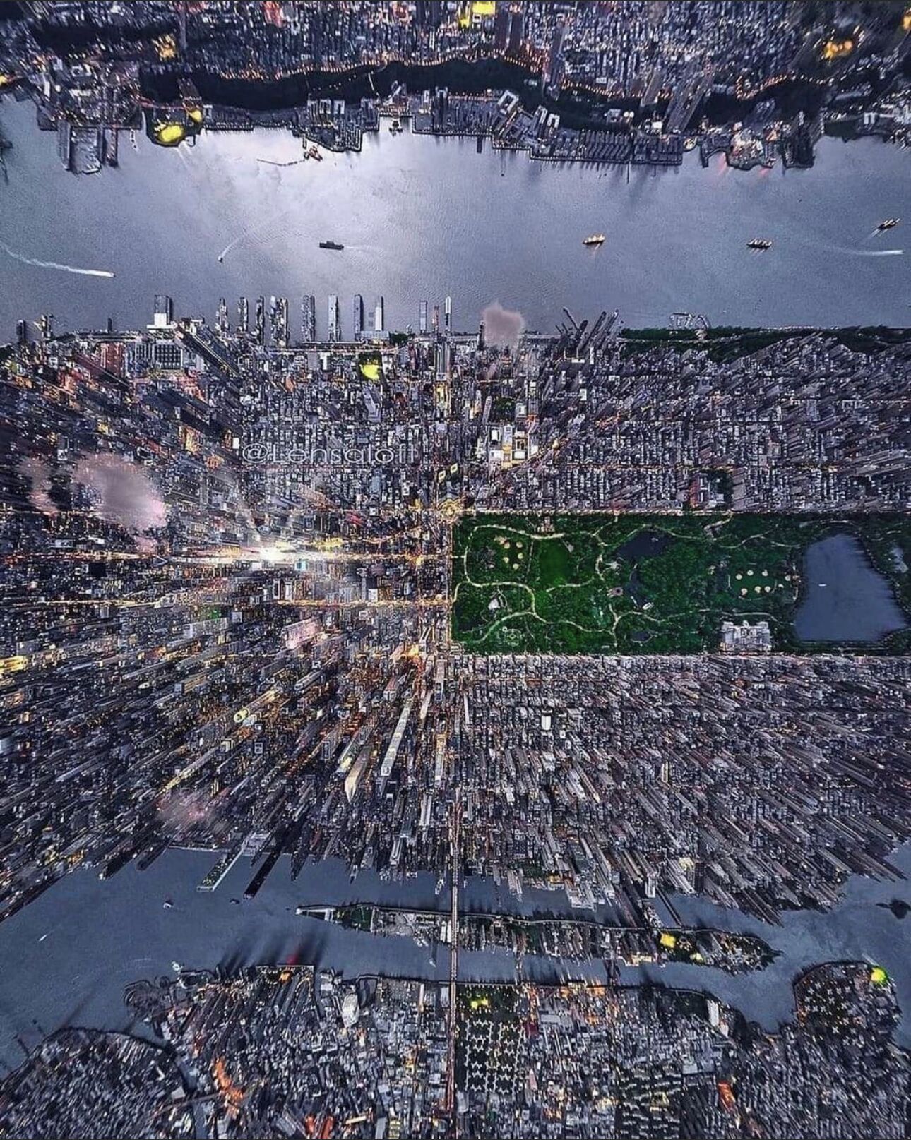 An aerial view of a densely packed urban area with a large green park in the center.