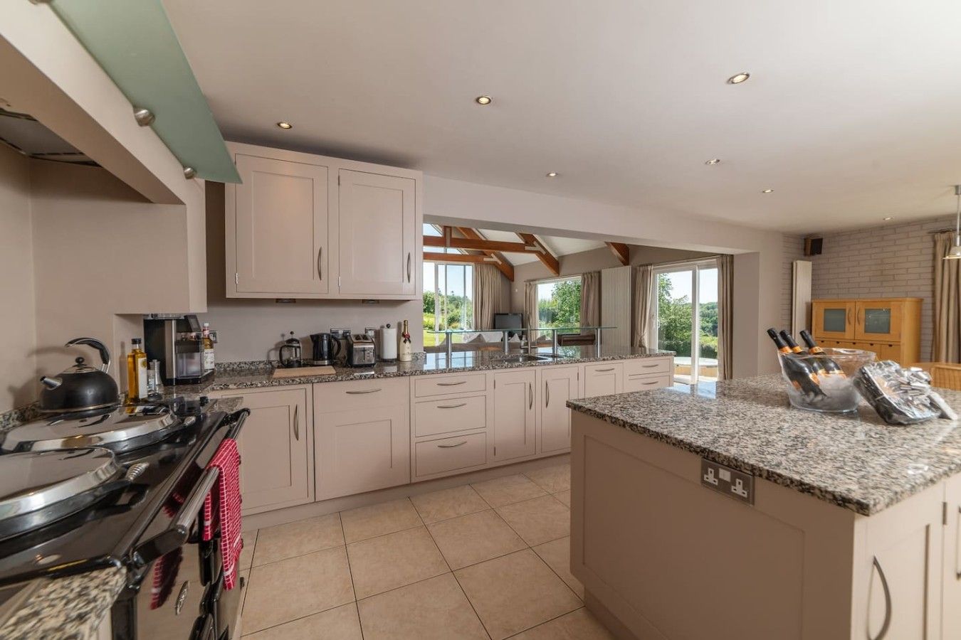 A modern kitchen with granite countertops, stainless steel appliances, and a large island.