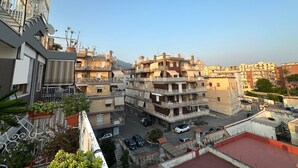 A multi-story residential building with balconies, a parking area, and a red-roofed section. - CasaCondo on Golden Mile - Twin Apartments by UNESCO Wonders for Large Groups (Torre del Greco)