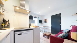 A compact living space with a kitchenette, a dining area, and a sofa. - La Seurinade Bassin d'Arcachon (Unknown)
