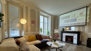 A living room with a sectional sofa, a coffee table, and a fireplace. - Villa in Le Mans Near Plantagenet City (Le Mans)
