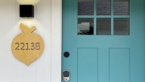 A teal door with a window and a wooden mailbox with the number 2213B. - Uptown Peach ~ Great base 4 your Waco adventures! (Waco)