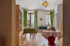 A dining area with a table, chairs, and a decorative animal statue.