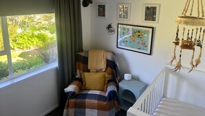 A cozy bedroom with a bed, a window with curtains, a map on the wall, and a hanging dreamcatcher. - Where comfort meets the mountains—close to everything,spacious,and pet-friendly! (Cromwell)