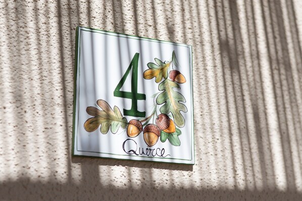 A house number sign with a number 4 and the word 'Quercia' on it.