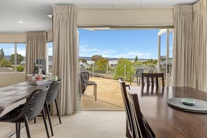 A dining area with a view of the cityscape through large windows.
