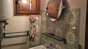 A bathroom with a sink, mirror, towel rack, and a window with a wooden frame. - Chalet 'Les Iris' with Mountain View and Private Garden (Unknown)