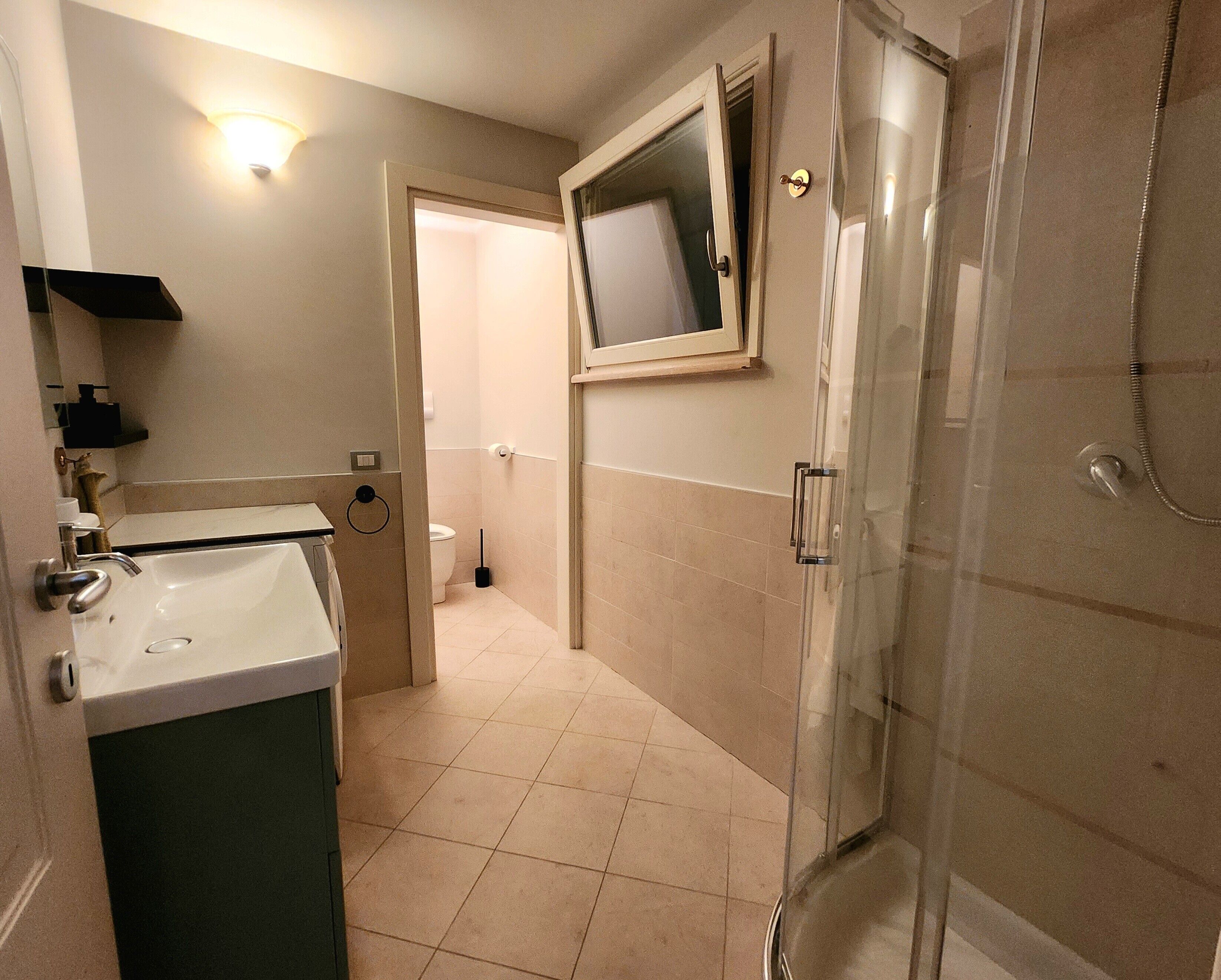 A bathroom with a sink, toilet, and shower.