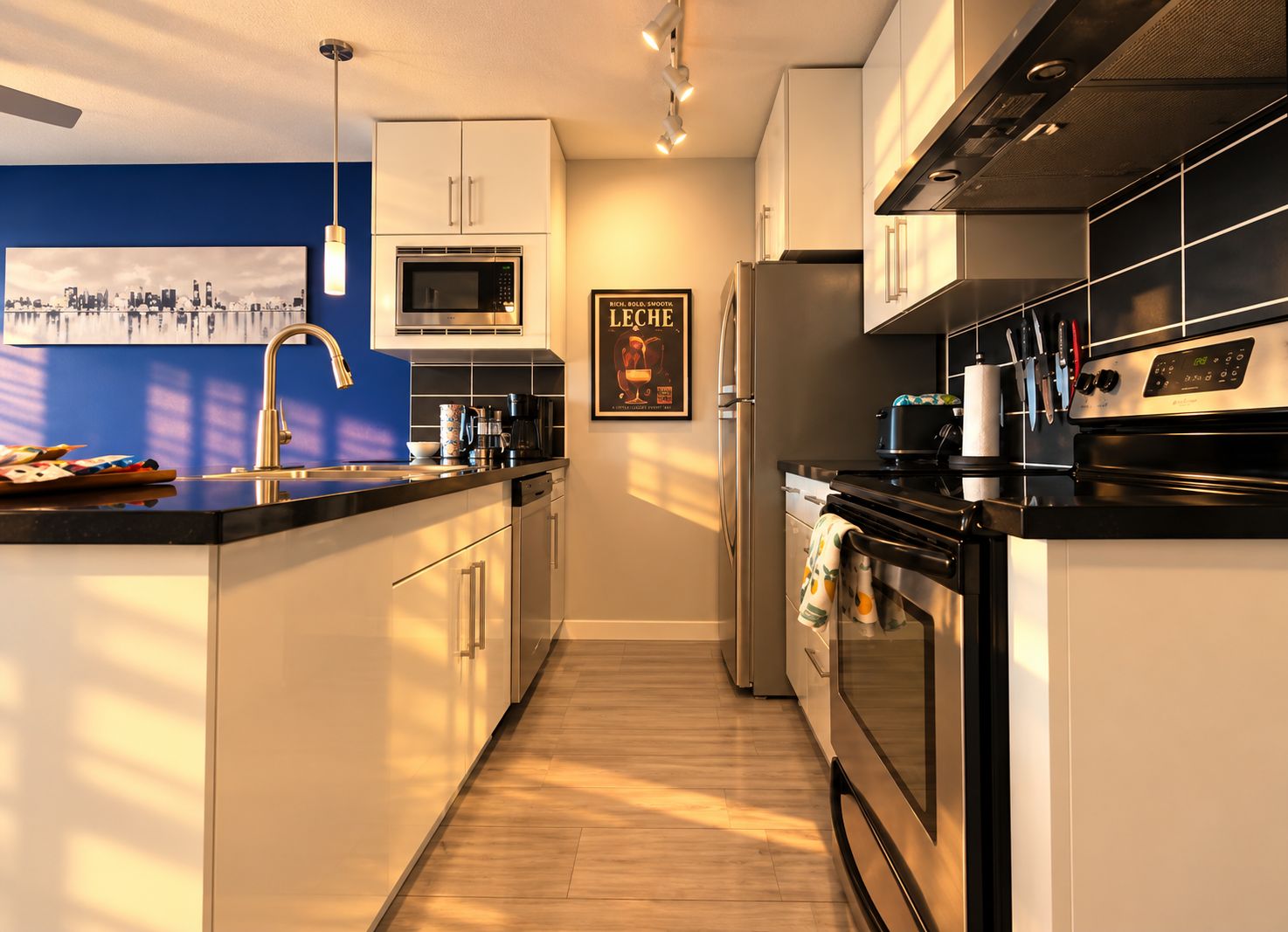 A modern kitchen with a microwave, refrigerator, and stove.