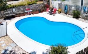 A swimming pool with a wooden deck, a barbecue grill, and outdoor furniture. - Charming 2nd floor 2-bedroom apartment in wonderful Surfside Beach, SC. (Surfside Beach)