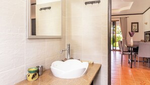 A bathroom with a white sink, a mirror, and a wooden countertop. - Private pool villa 50 meters from the beach 🏝 (Ban Tai)